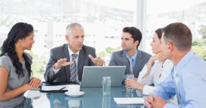 Blogs 6 Financial advisor leading a strategy meeting with team members, symbolizing productivity and smart delegation in financial practice management.