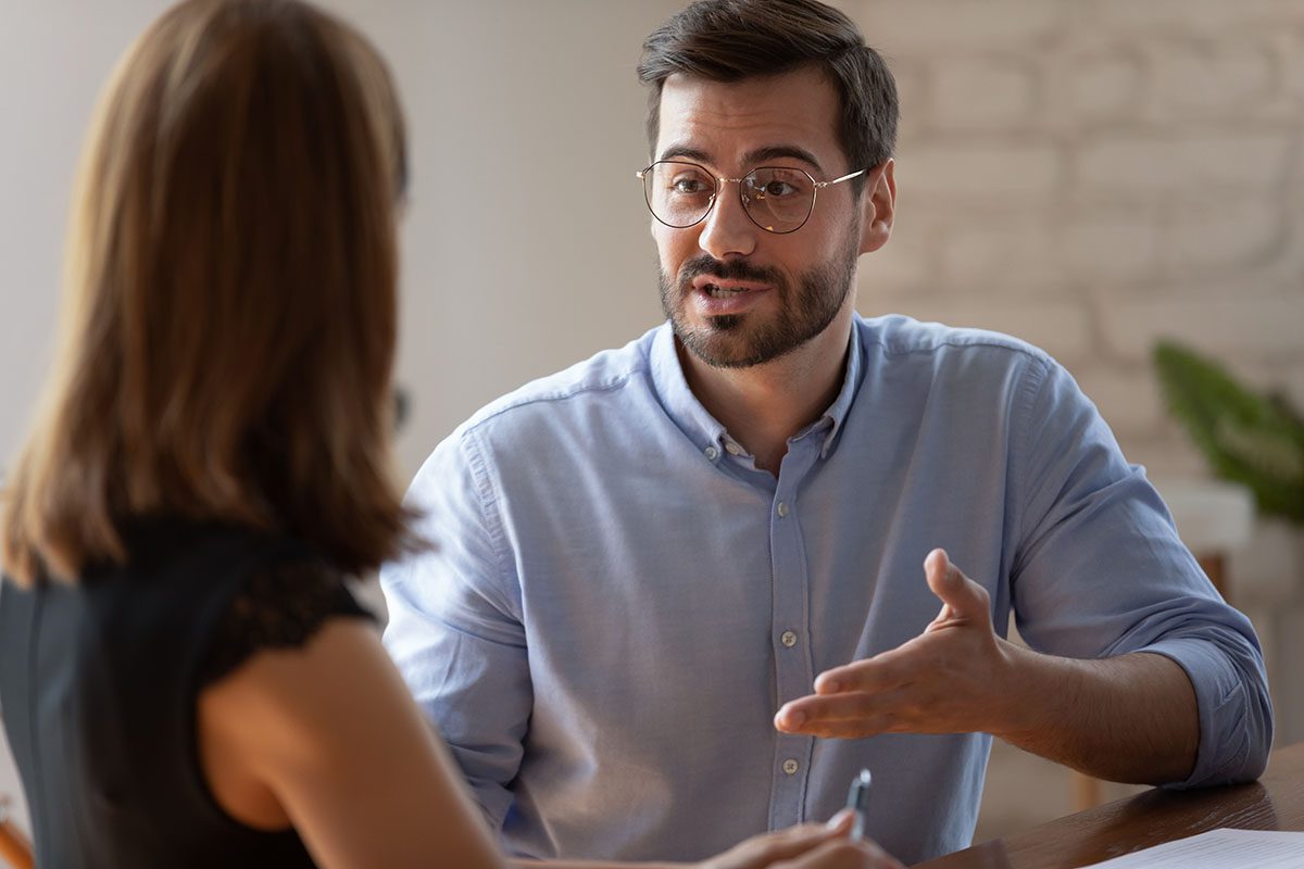 A Financial Gravity Family Office Director, a financial advisor, engaging in a client meeting, demonstrating how delegation maximizes efficiency and revenue growth.