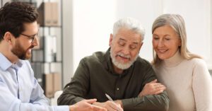 Blogs 5 Financial advisor meeting with an older couple, building trust through proactive planning powered by Financial Gravity.