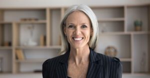 Experienced financial advisor smiling confidently, representing the freedom and growth possible with Financial Gravity’s support.