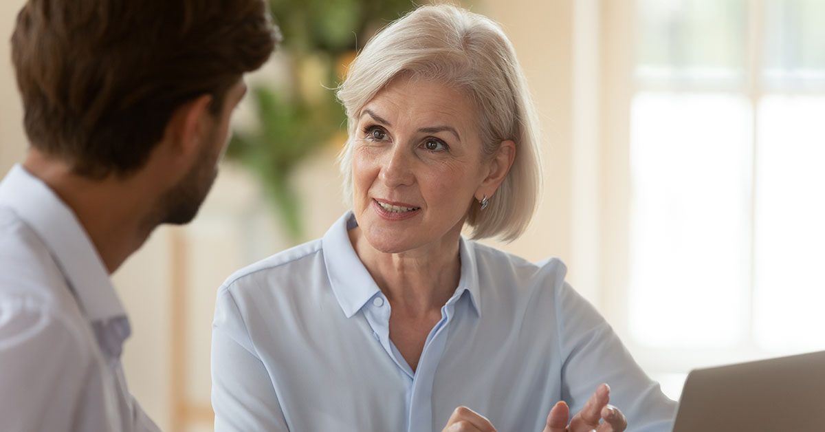 Financial advisor in a one-on-one meeting with a niche client, symbolizing the focus and trust that comes from specialization.