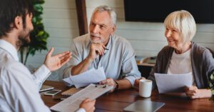 Financial advisor meeting with an older couple, demonstrating Financial Gravity’s focus on empathy and multi-family office services that build trust and lasting client relationships.