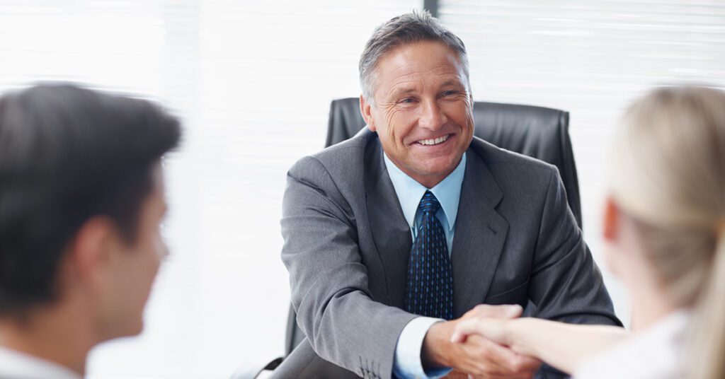 inancial Gravity helps financial advisors reclaim time, shown by a confident advisor greeting clients at a meeting.