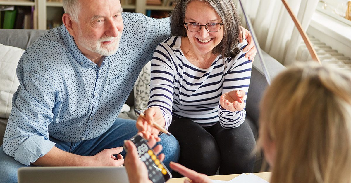 Financial Gravity helps financial advisors combine human insight with coordinated planning, shown by a smiling couple reviewing options with their adviso