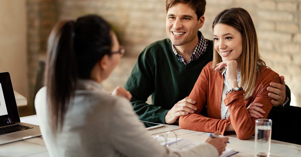 A financial advisor meets with a couple to simplify financial decisions and provide clear guidance in a supportive setting.
